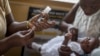 Seorang bayi perempuan menerima suntikan vaksin Malaria "Mosquirix" di sebuah klinik di Cape Coast, Ghana. 