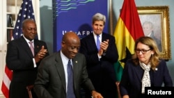 De Gauche à droite, l’ancien président du Ghana, John Dramani Mahama, l’ancien ministre des Finances du Ghana, Seth Terkper, l’ancien secrétaire d'État américain John Kerry et Dana Hyde, PDG de la Millennium Challenge Corporation (MCC), participent à la cérémonie de signature du Compact du Ghana au Département d'Etat à Washington, 25 août 2014.