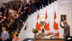 FILE - Britain's Prince Charles, now King Charles III, greets people during his visit to Canada House in London, May 12, 2022. 