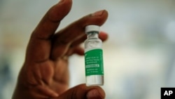 FILE - In this March 24, 2021, photo, a nurse holds a vial of the AstraZeneca COVID-19 vaccine, manufactured by the Serum Institute of India and provided through the global COVAX initiative.