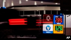 FILE - Motorists pass posted gas prices, June 10, 2024, in San Antonio, Texas. Government data released on Aug. 14, 2024, showed inflation increased in July at its lowest annual rate since March 2021.