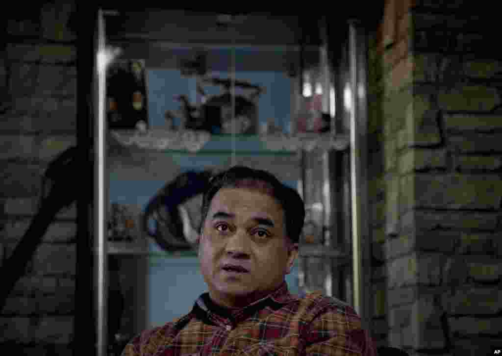 In this Feb. 4, 2013 photo, Ilham Tohti, an outspoken scholar of China's Turkic Uighur ethnic minority, pauses during an interview at his home in Beijing, China. Tohti was set to go on trial on separatism charges on Sept. 17, 2014.