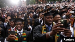 FILE - Members of a graduating class take pictures at their graduation ceremony at Morehouse College in Atlanta, Georgia, May 19, 2013.