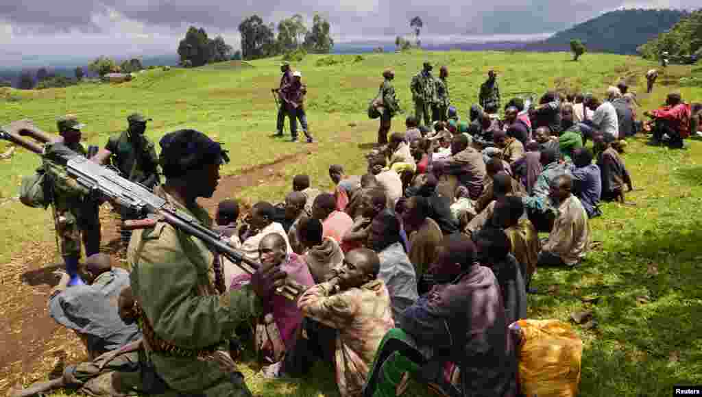 M23 During two years of civil war, units of M23 rebels sought haven in Virunga National Park where officials say they fueled regional violence against civilians, hippos and game wardens. M23 fighters sat under guard (above) near Goma during a November 2013 negotiated settlement with the Democratc Republic of Congo. 