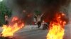 FILE - Anti-government protesters set fires and close a street during a demonstration in Baghdad, Iraq, Oct. 6, 2019. 