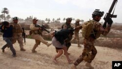 FILE - Iraqi security forces arrest suspected Islamic State militants in Jurf-al-Sakhar, 60 km (40 miles) from Baghdad, Feb. 15, 2014.