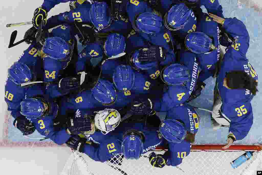 Team Sweden celebrates their 4-0 victory over Germany during the 2014 Winter Olympics women's ice hockey game at Shayba Arena, Sochi, Russia, Feb. 11, 2014.