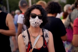 A woman takes part in a protest against Madrid's new conservative People's Party municipal government plans to suspend some anti-car emissions policies in the city center, June 29, 2019.