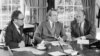 FILE - Then-vice presidential nominee Gerald R. Ford (R) listens as President Richard Nixon, accompanied by Secretary of State Henry Kissinger, speaks in the Oval Office of the White House in Washington, Oct. 13, 1973.