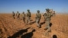 FILE - U.S. and Turkish soldiers conduct the first-ever combined joint patrol outside Manbij, Syria, Nov. 1, 2018, in this U.S. Army handout photo provided by Reuters.