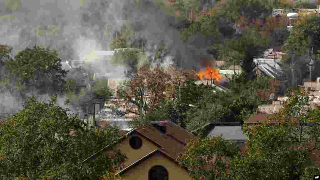 Smoke rises over a residential neighborhood near the airport after shelling in the town of Donetsk, eastern Ukraine, Oct. 1, 2014.