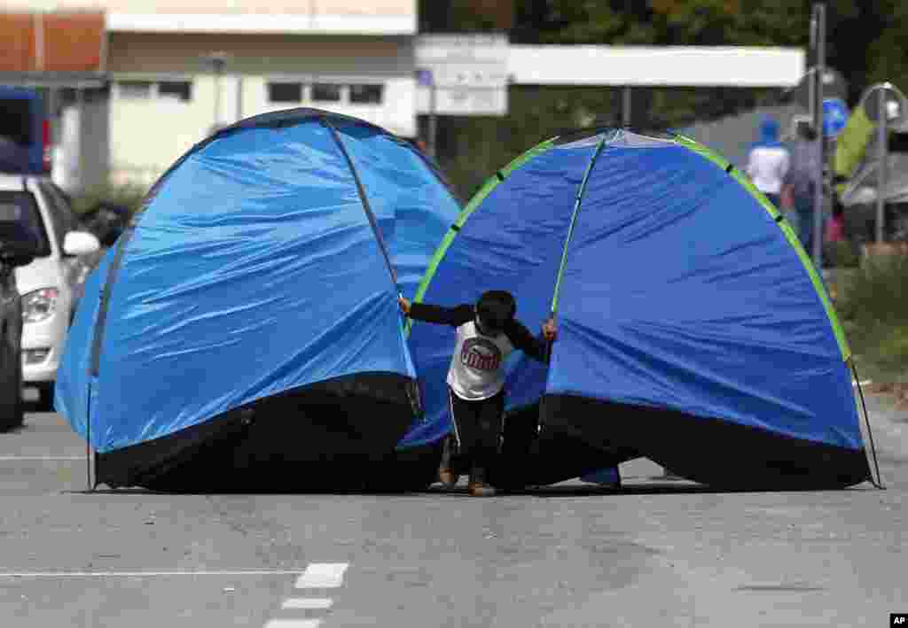 A migrant boy pulls tents on the road near the "Horgos 2" border crossing into the Hungary, near Horgos.