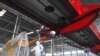 FILE - A worker in protective suit disinfects a factory before it resumes operation on Feb. 10 following an extended Lunar New Year holiday caused by the novel coronavirus outbreak, in Lianyungang, Jiangsu province, China, Feb. 9, 2020.