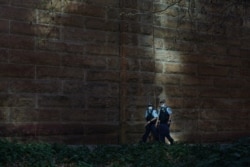 Masked police officers patrol the quiet city centre during a lockdown to curb a coronavirus disease (COVID-19) outbreak in Sydney, Australia, August 20, 2021.