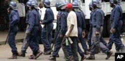 Zimbabwean police arrest an MDC supporter in Harare recently … Activists say ongoing political unrest in Zimbabwe makes it dangerous for migrants in South Africa to return to their homeland