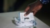 An election commission worker counts votes at a polling station in Dakar, Senegal, March 24, 2024. 