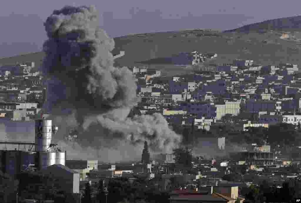 Smoke rises following an airstrike by the US-led coalition during fighting between Syrian Kurds and the Islamic State militants, as seen from the outskirts of Suruc, on the Turkey-Syria border, Oct. 10, 2014.