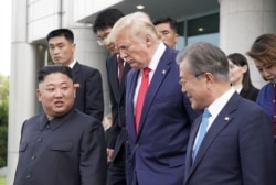 FILE - U.S. President Donald Trump, North Korean leader Kim Jong Un and South Korean President Moon Jae-in leave after a meeting at the demilitarized zone separating the two Koreas, in Panmunjom, South Korea, June 30, 2019.
