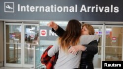 FILE - Mahnaz Kanani Zadeh, right, is greeted by her niece Negin after traveling to the U.S. from Iran following a federal court's temporary stay of U.S. President Donald Trump's executive order travel ban, at Logan Airport in Boston, Massachusetts, Feb. 6, 2017. 