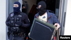 German special police leave a house in Berlin, Nov. 15, 2016.