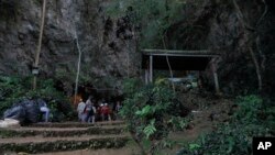 Rescue teams gather at the entrance of a deep cave where a group of boys went missing in Chiang Rai, northern Thailand, Monday, June 25, 2018. 