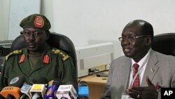 South Sudanese Minister of Information Barnaba Benjamin Marial, right, and Military Spokesman Philip Aguer brief the median Juba, south Sudan about recent fighting between Sudanese and South Sudanese forces along the north-south border, FILE March 27, 201