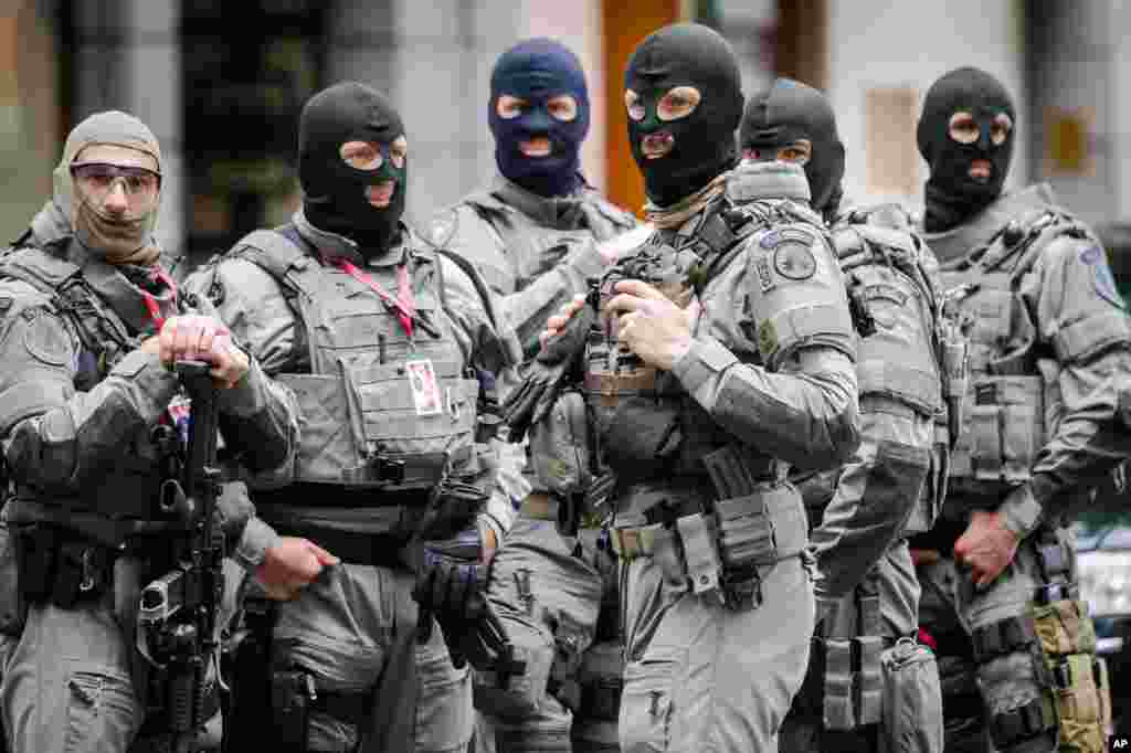 Officers of the Belgian Special Police patrol around the perimeter of the hotel of U.S. President Barack Obama in Brussels, June 4, 2014.