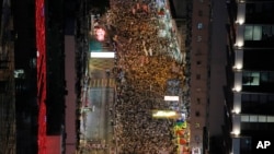 FILE - People march during an annual protest in downtown Hong Kong Tuesday, July 1, 2014.