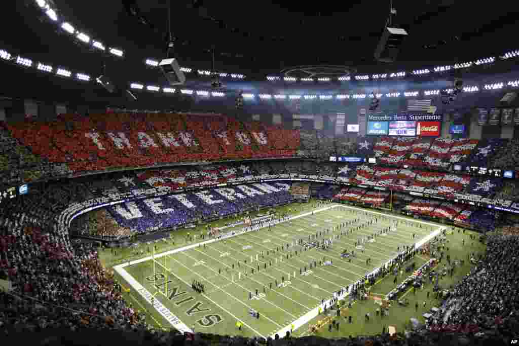 An overall inside view of the Mercedes-Benz Superdome as fans honor military and veterans before an NFL game between the Dallas Cowboys and the New Orleans Saints, Nov. 10, 2013.