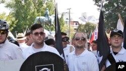 FILE - James Fields, second from left, holds a black shield in Charlottesville, Va., where a white supremacist rally took place, Aug. 12, 2017. Fields was later charged after authorities say he plowed a car into a crowd of people protesting the white nati