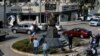 People gather near a statue of Iranian General Qassem Soleimani, who was the head of Iran's Quds force, that was installed to commemorate the anniversary of his killing, in a U.S. drone strike, in Lebanon, Jan. 6, 2021. 