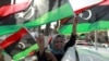 A woman celebrates on the streets in Tripoli's Martyrs Square after casting her vote during Libya's National Assembly election, July 7, 2012. 