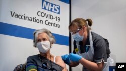 Dr Doreen Brown, 85, receives the first of two Pfizer/BioNTech COVID-19 vaccine jabs administered at Guy's Hospital in London, Dec. 8, 2020. 