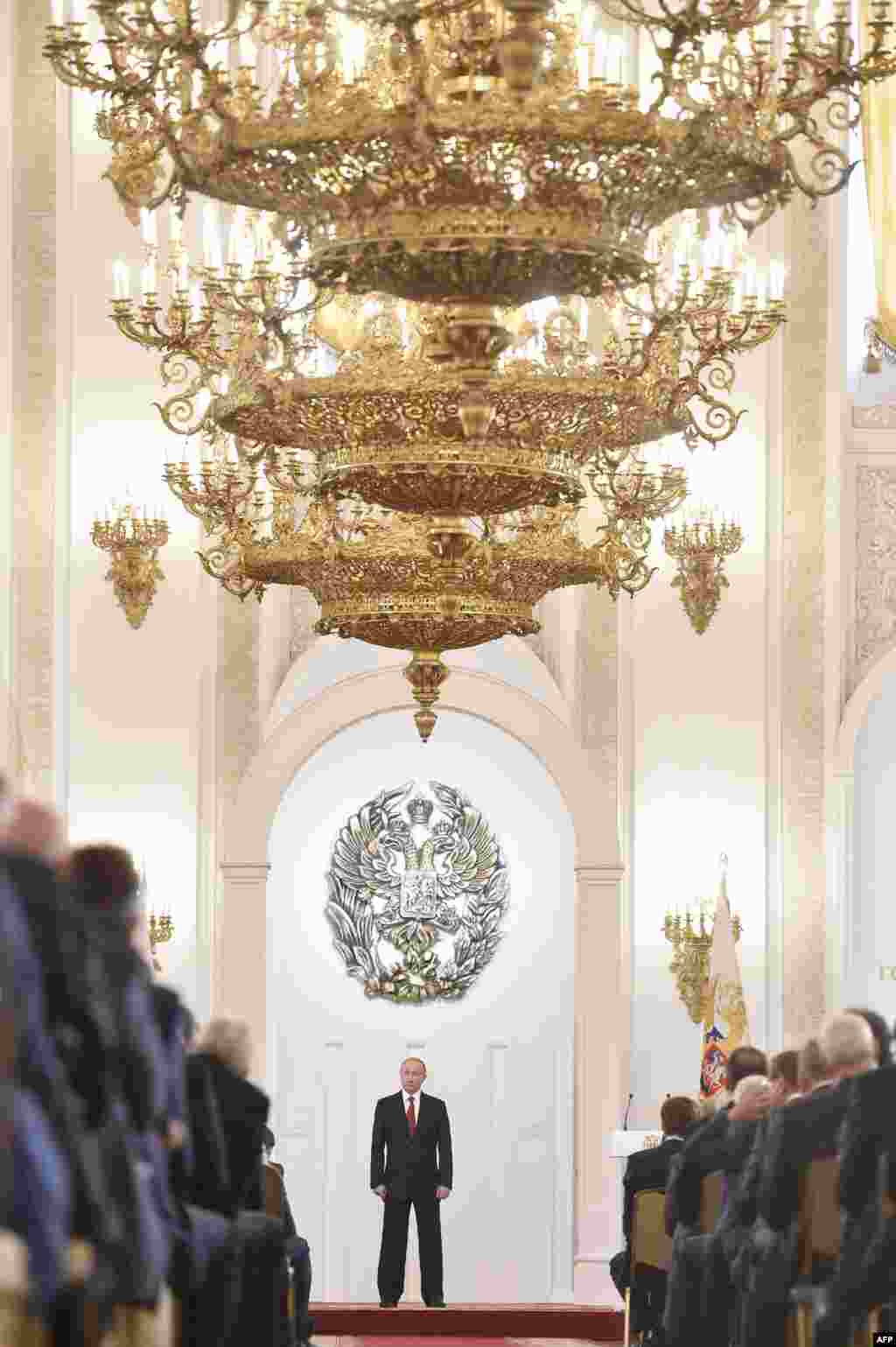 Russian President Vladimir Putin stands during the State Prize awards ceremony marking the 'Day of Russia' at the Grand Kremlin Palace in Moscow.