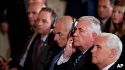 Vice President Mike Pence, right, Secretary of State Rex Tillerson, 2nd right, attend a news conference between President Donald Trump and Colombian President Juan Manuel Santos in the East Room of the White House, May 18, 2017, in Washington.