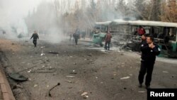People react to a bus that was hit by an explosion in Kayseri, Turkey, Dec. 17, 2016.