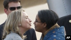 U.S. Secretary of State Hillary Rodham Clinton, left, is greeted by Bangladeshi Foreign Minister Dipu Moni upon her arrival in Dhaka, Bangladesh, May 5, 2012.