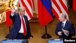 U.S. President Donald Trump and Russian President Vladimir Putin react at the end of the joint news conference after their meeting in Helsinki, Finland, July 16, 2018.