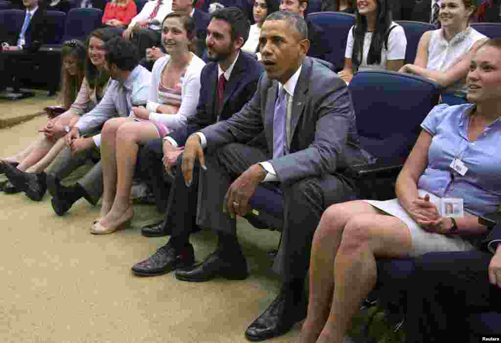 U.S. President Barack Obama watches the match between the U.S. and Belgium during a staff viewing party in an auditorium at the Eisenhower Executive Office Building in Washington, July 1, 2014.