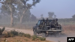 FILE - Members of the Cameroonian Rapid Intervention Force patrol on the outskirts of Mosogo in the Far North region of the country where Boko Haram jihadist have been active, March 21, 2019.
