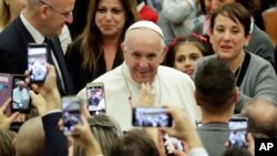 Pope Francis arrives for an audience with Vatican employees, in the Pope Paul VI hall, at the Vatican, Friday, Dec. 21, 2018. 