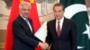 Pakistan's Foreign Minister Khawaja Muhammad Asif, left, and Chinese Foreign Minister Wang Yi shake hands at the end of a joint press conference at the Diaoyutai State Guesthouse in Beijing, Sept. 8, 2017.