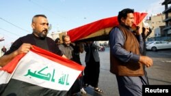 Mourners carry the coffin of a demonstrator who was killed at an anti-government protest in Nassiriya, during a funeral in Najaf, Iraq, Nov. 28, 2019.