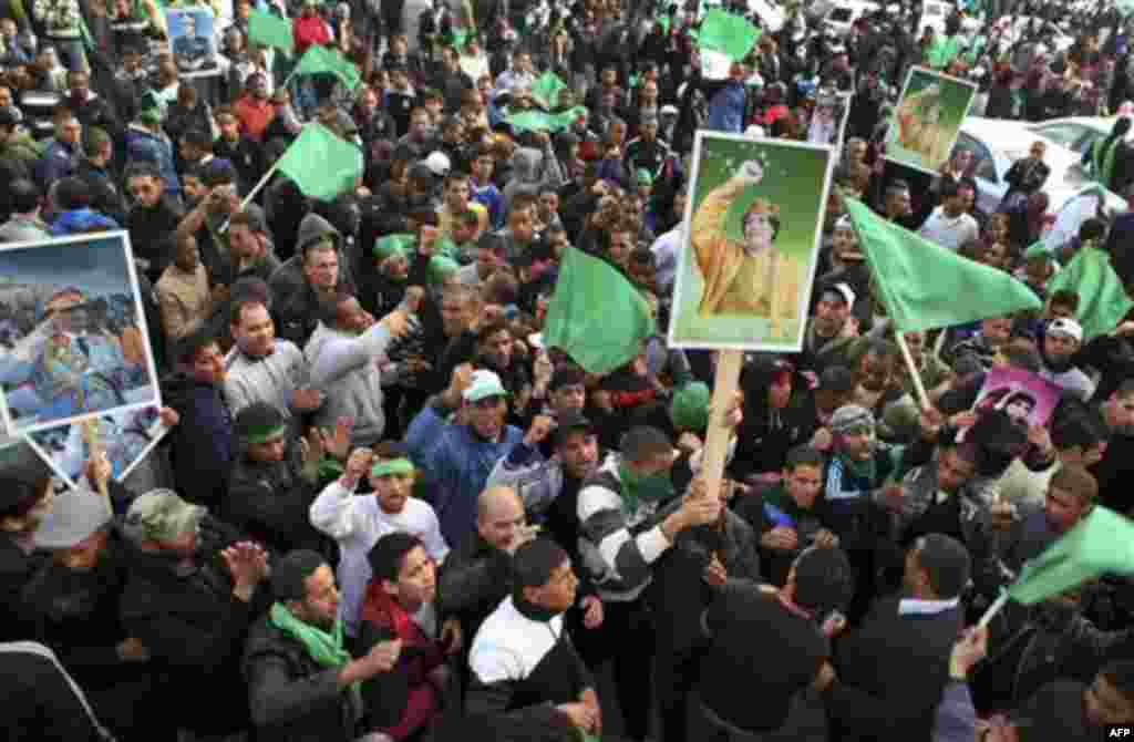 Pro-Gadhafi supporters gather in Green Square after traditional Friday prayers in Tripoli, Libya, Friday, Feb. 18, 2011. Protesters battled with security forces for control of neighborhoods Friday in eastern Libya where dozens have reportedly been killed