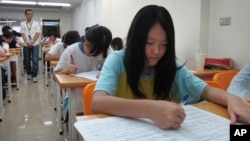 FILE - Junior high students study in a small cram school in hopes of success on their high school entrance exams, in Taipei, Taiwan.