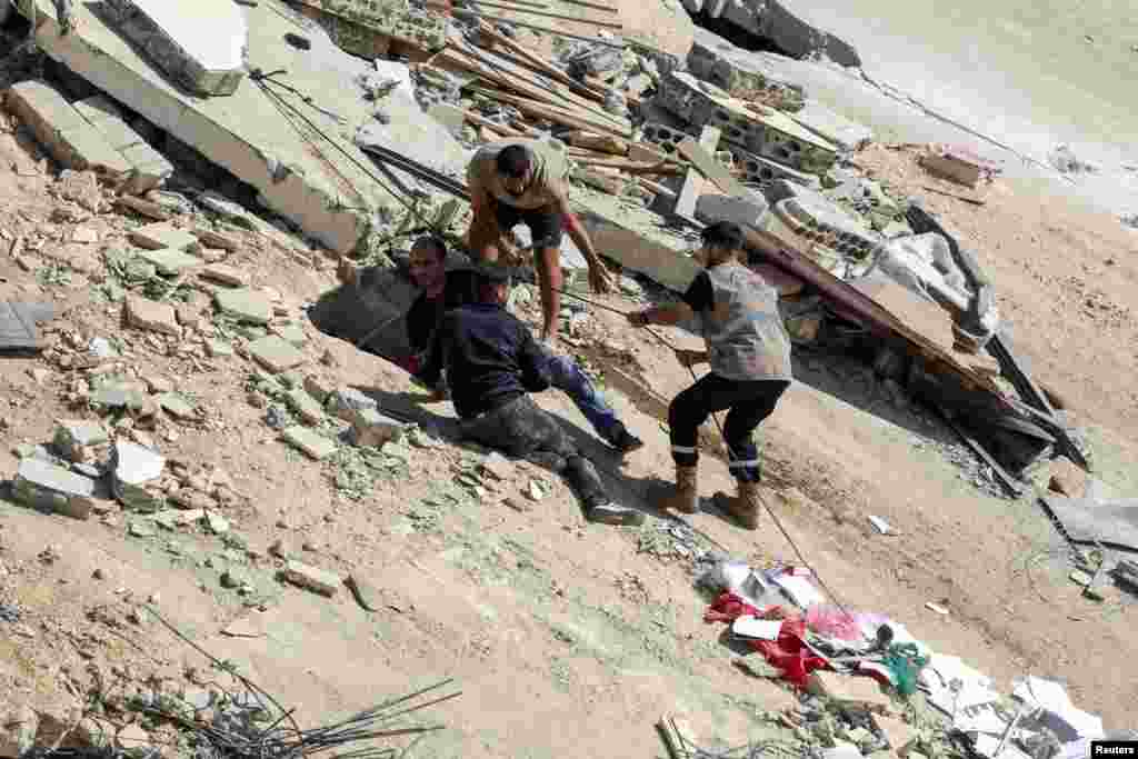 People carry out a rescue operation at the site of Sunday's Israeli attack on the city of Ain Deleb, amid the ongoing hostilities between Hezbollah and Israeli forces, in southern Lebanon.