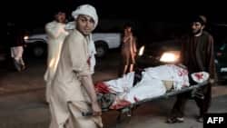 Afghan men carry a wounded man into a hospital following a car bomb explosion in Lashkargah, capital of Helmand province, Afghanistan, March 23, 2018. The attack prompted locals to stage an anti-war protest. 