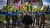 Ukrainian President Volodymyr Zelenskyy poses for a photo with Ukrainian soldiers in front of a road sign marking the entrance to the Donetsk region, amid the Russian invasion of Ukraine. (Ukrainian Presidential Press Service via AFP)
