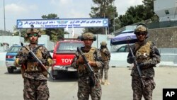 FILE - In this Aug. 31, 2021, photo, Taliban special forces fighters stand guard outside the Hamid Karzai International Airport after the US military's withdrawal, in Kabul, Afghanistan.