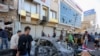 Iraqis gather at the site of a bomb explosion near Baghdad's Tahrir Square, Nov. 16, 2019.